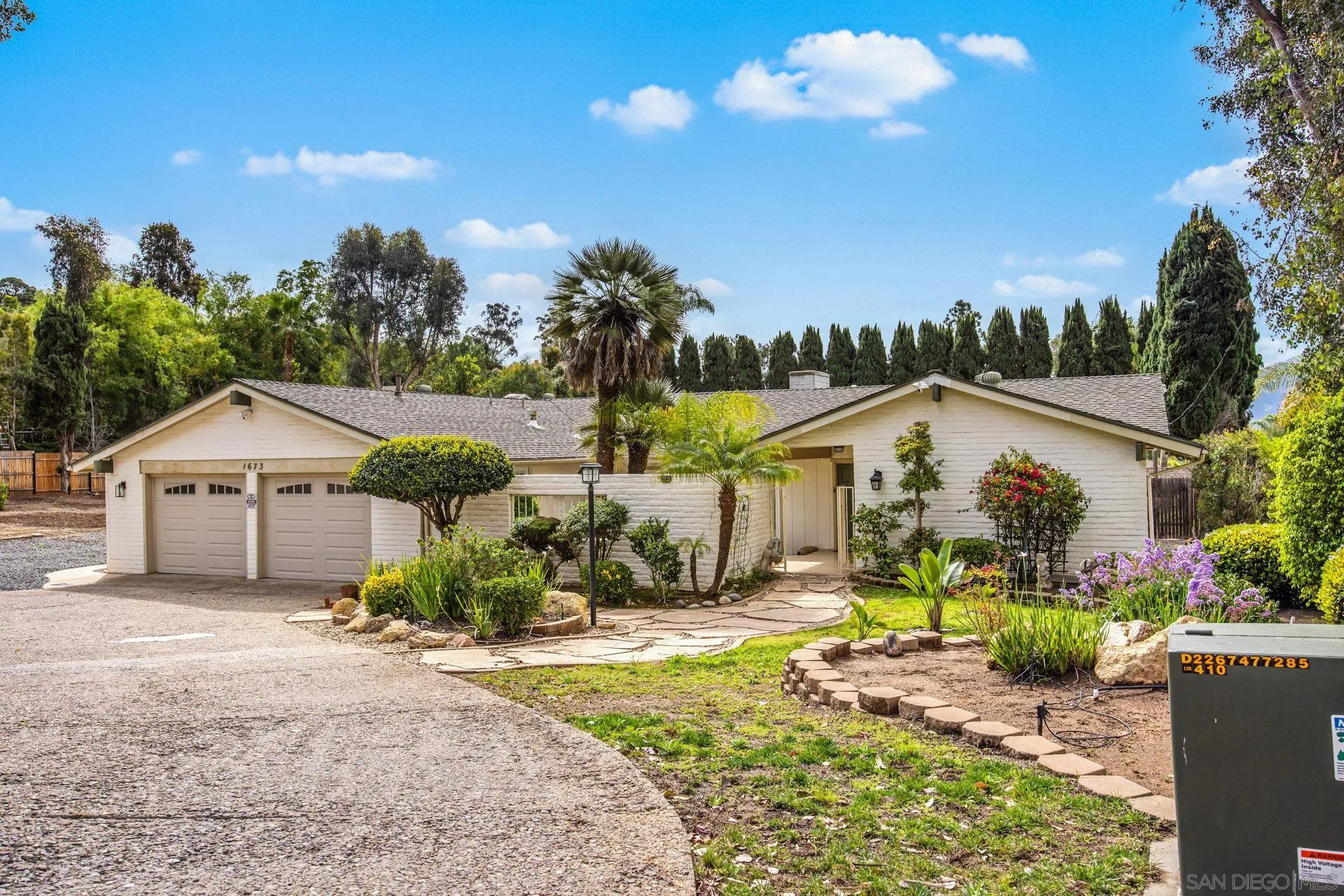 1673 Hidden Mesa Road El Cajon, CA 92019 - Photo 3 of 29 a front view of a house with a yard and potted plants