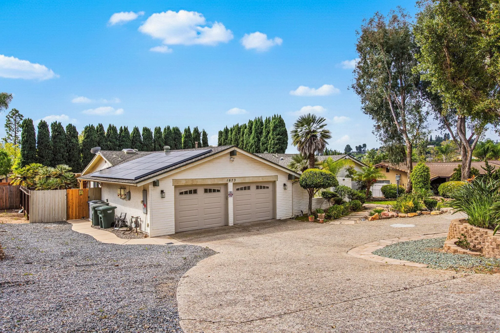 1673 Hidden Mesa Road El Cajon, CA 92019 - Photo 4 of 29 a view of a house with a yard and potted plants