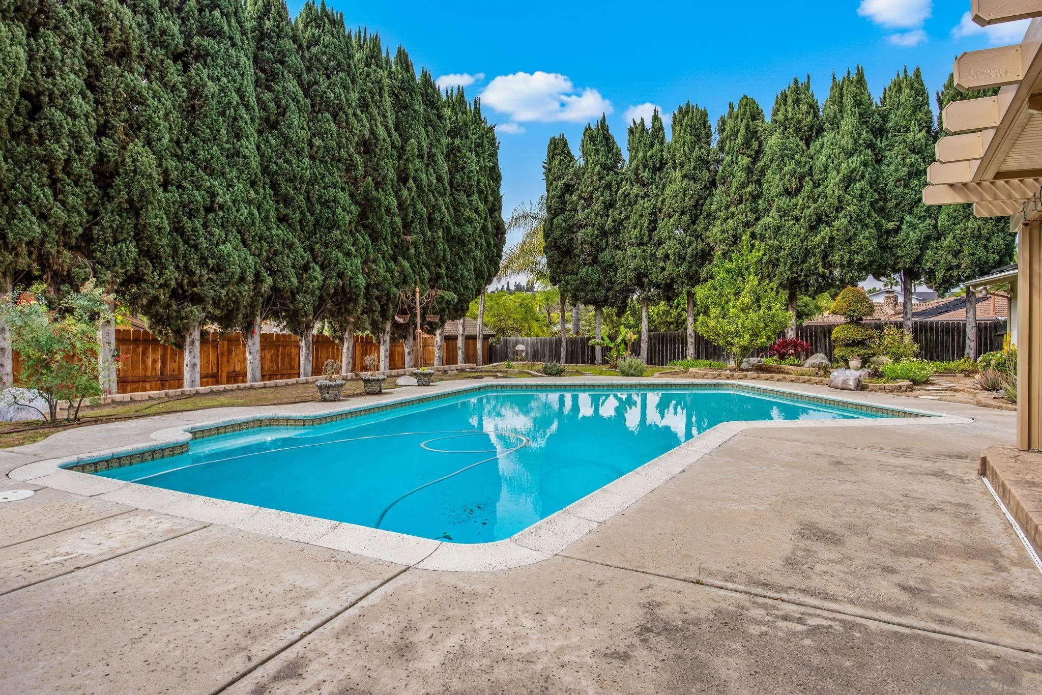 1673 Hidden Mesa Road El Cajon, CA 92019 - Photo 7 of 29 a view of swimming pool with outdoor seating and trees in the background