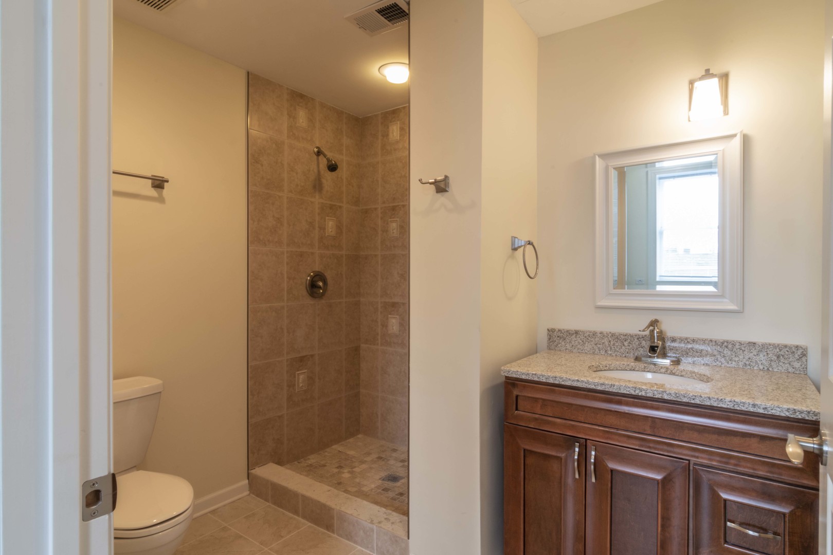 1761 West Augusta Boulevard, Unit 2F Chicago, IL 60622 - Photo 3 of 5 a bathroom with a sink a toilet and shower