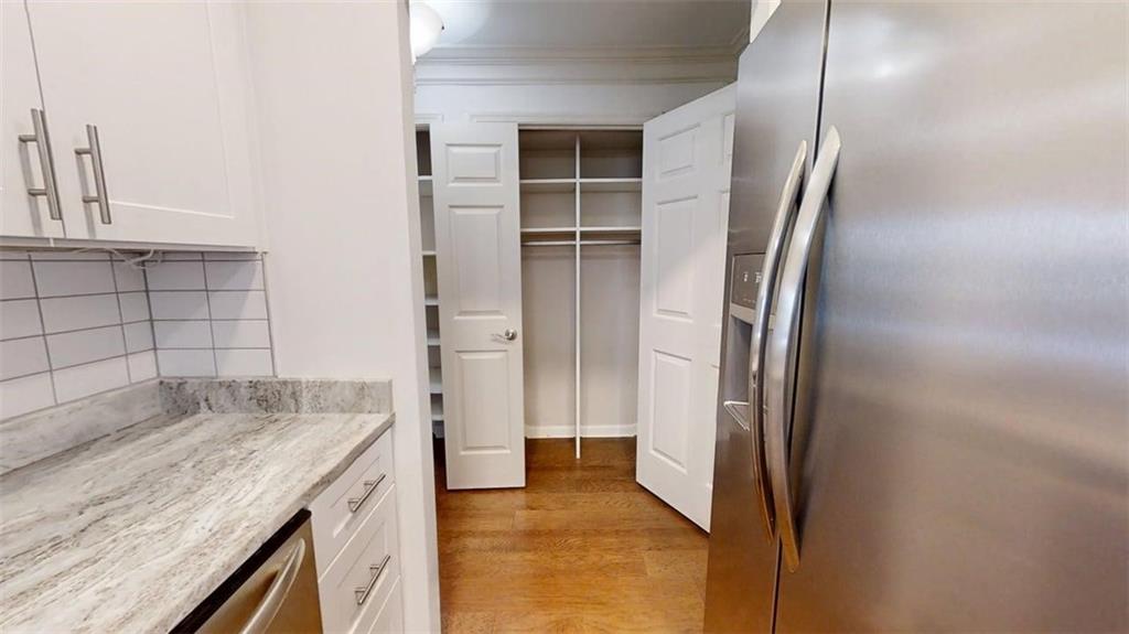 300 Johnson Ferry Road, Unit B201 Atlanta, GA 30328 - Photo 14 of 32 a view of kitchen with cabinets and wooden floor