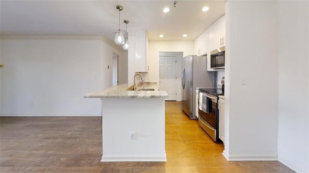 300 Johnson Ferry Road, Unit B201 Atlanta, GA 30328 - Photo 16 of 32 a bathroom with a sink a mirror and a shower