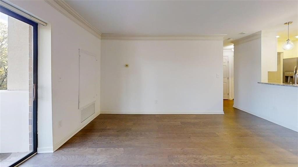 300 Johnson Ferry Road, Unit B201 Atlanta, GA 30328 - Photo 18 of 32 an empty room with wooden floor and windows