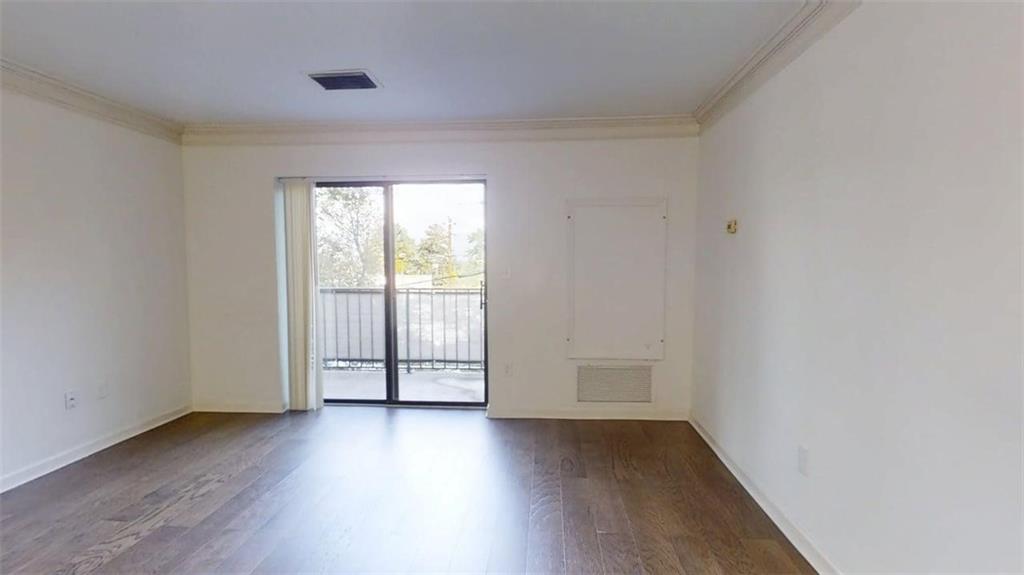 300 Johnson Ferry Road, Unit B201 Atlanta, GA 30328 - Photo 19 of 32 an empty room with wooden floor and windows