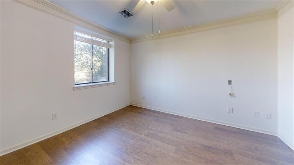 300 Johnson Ferry Road, Unit B201 Atlanta, GA 30328 - Photo 26 of 32 an empty room with wooden floor chandelier fan and windows