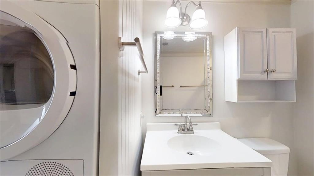 300 Johnson Ferry Road, Unit B201 Atlanta, GA 30328 - Photo 28 of 32 a bathroom with a sink a mirror and vanity