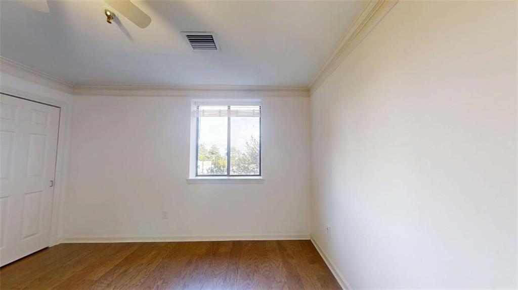 300 Johnson Ferry Road, Unit B201 Atlanta, GA 30328 - Photo 29 of 32 an empty room with wooden floor and windows