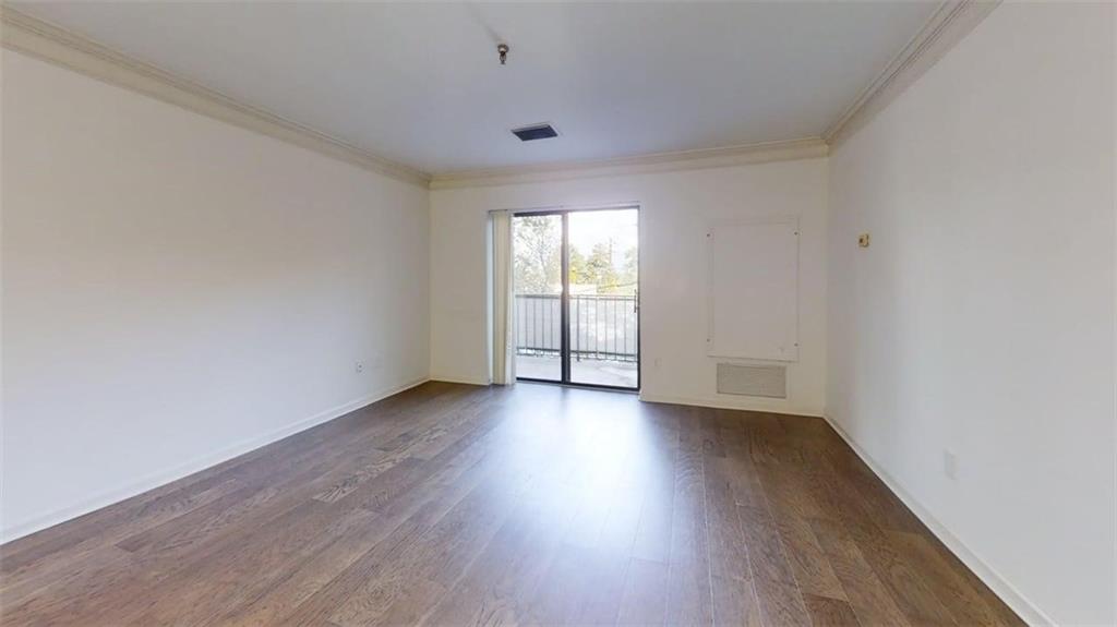300 Johnson Ferry Road, Unit B201 Atlanta, GA 30328 - Photo 31 of 32 an empty room with wooden floor and windows