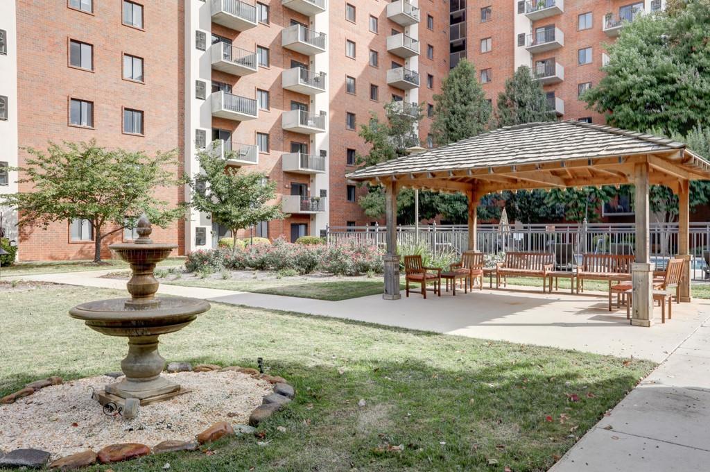 300 Johnson Ferry Road, Unit B201 Atlanta, GA 30328 - Photo 6 of 32 a view of a building with sitting area and garden