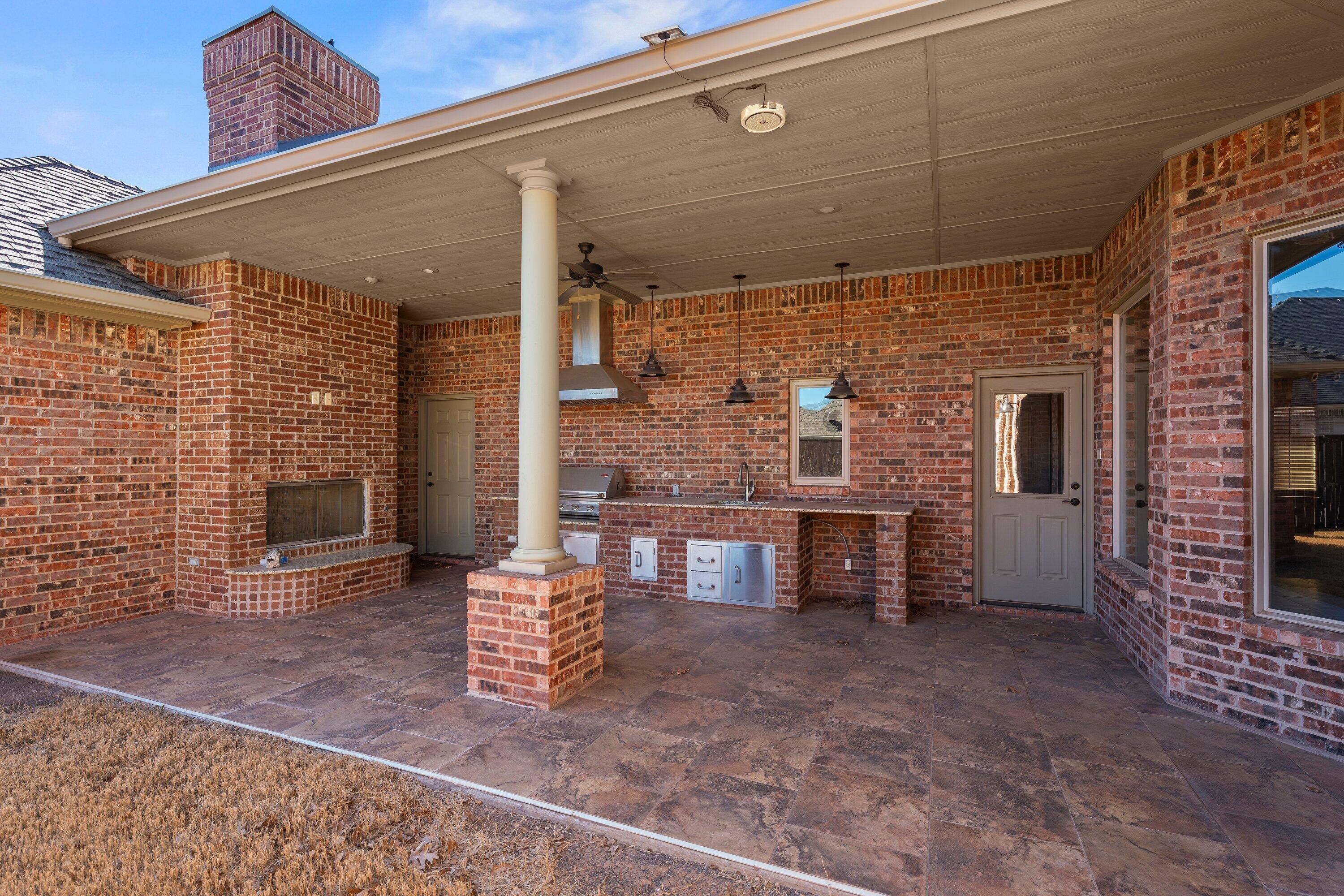 4507 101st Street Lubbock, TX 79424 - Photo 33 of 36 outdoor kitchen fireplace