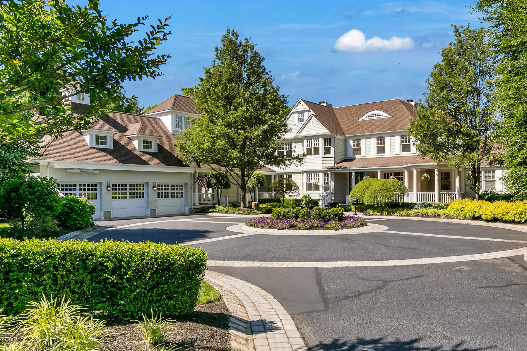 127 Ave Of Two Rivers Rumson, NJ 07760 - Photo 1 of 59 a front view of a house with a garden and plants