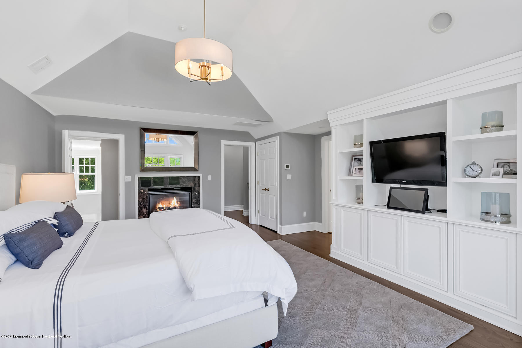 127 Ave Of Two Rivers Rumson, NJ 07760 - Photo 29 of 59 a bedroom with a bed and a flat tv screen on dresser
