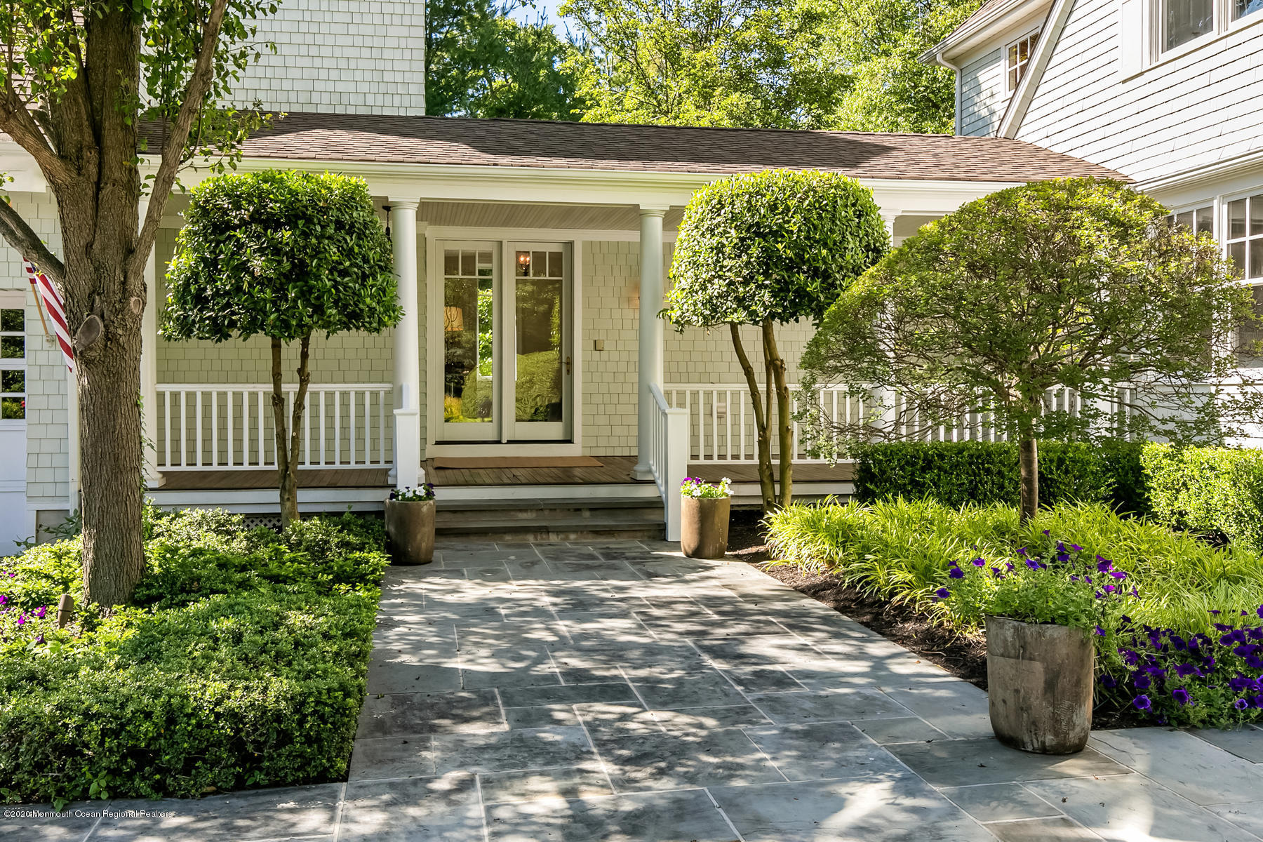 127 Ave Of Two Rivers Rumson, NJ 07760 - Photo 4 of 59 a front view of a house with a garden