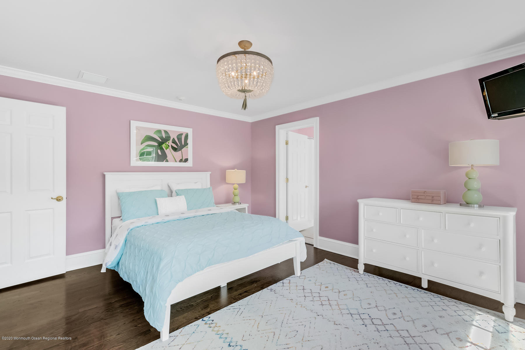 127 Ave Of Two Rivers Rumson, NJ 07760 - Photo 32 of 59 a bedroom with a bed and a chandelier