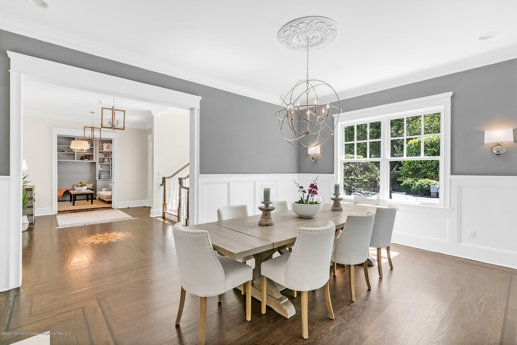 127 Ave Of Two Rivers Rumson, NJ 07760 - Photo 9 of 59 a dining room with wooden floor a chandelier a glass table and chairs