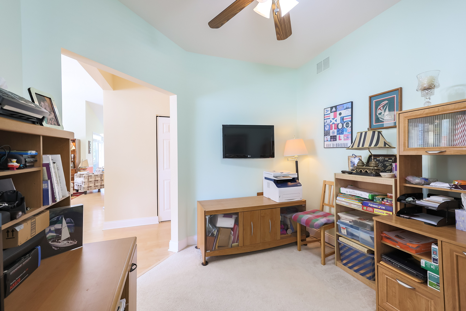 1472 Grand Haven Road Romeoville, IL 60446 - Photo 17 of 21 a room with furniture a flat screen tv and a book shelf