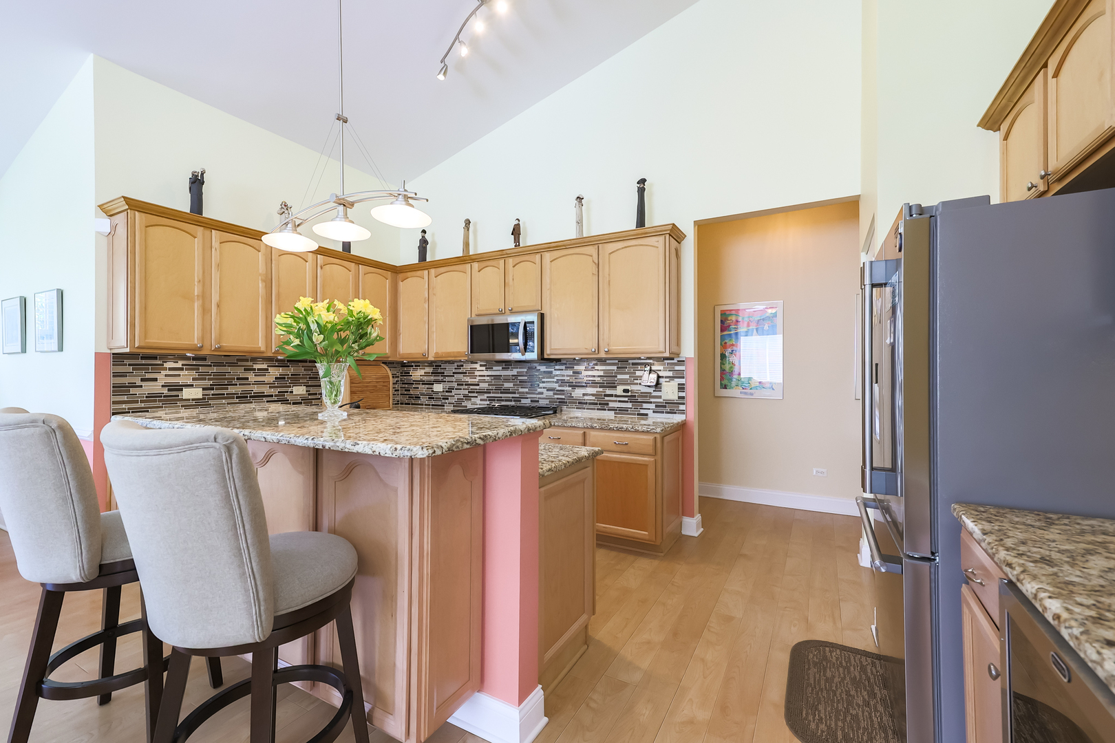 1472 Grand Haven Road Romeoville, IL 60446 - Photo 7 of 21 a kitchen with stainless steel appliances granite countertop a stove a refrigerator a kitchen island a sink and a refrigerator