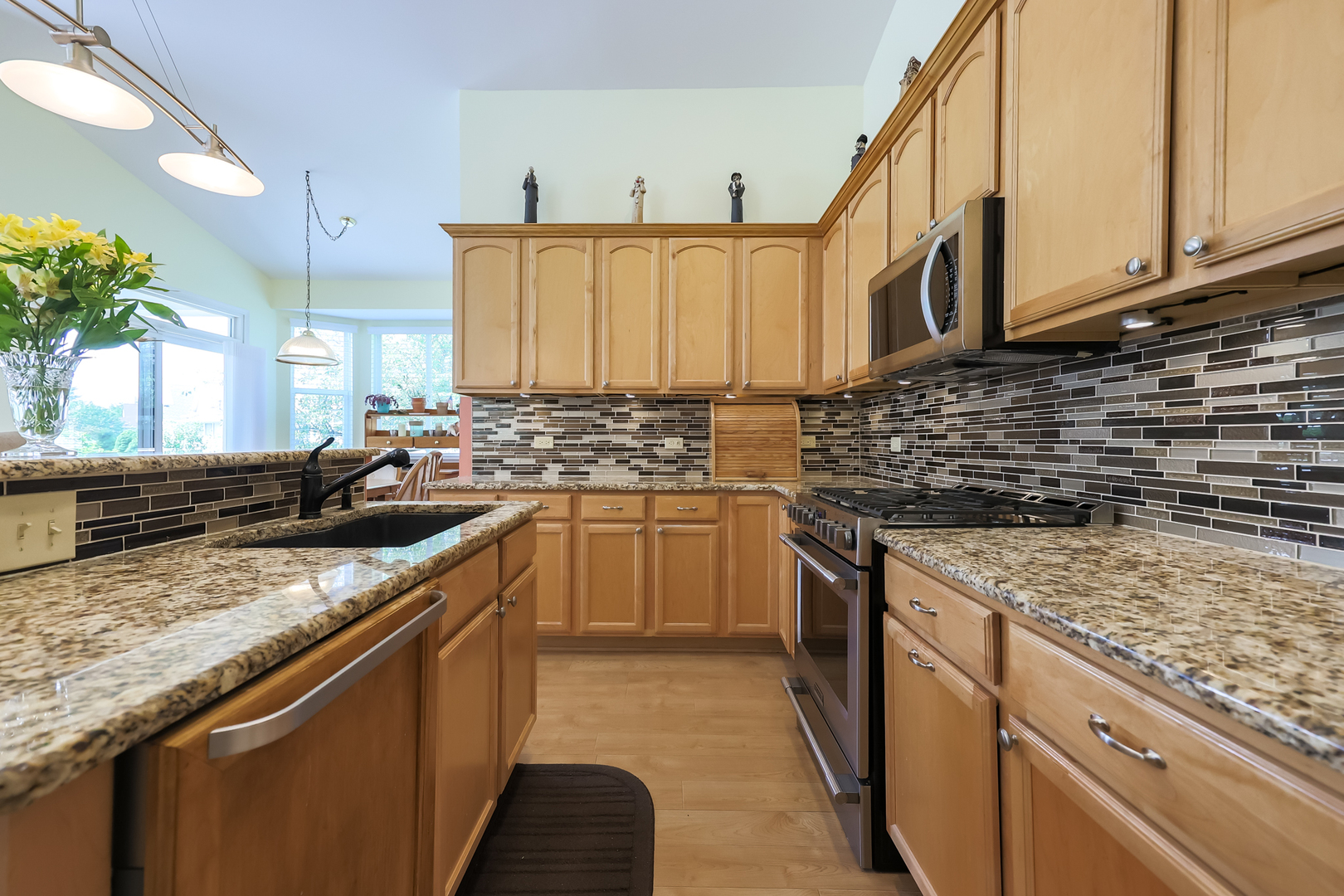 1472 Grand Haven Road Romeoville, IL 60446 - Photo 8 of 21 a kitchen with stainless steel appliances granite countertop a sink stove and cabinets