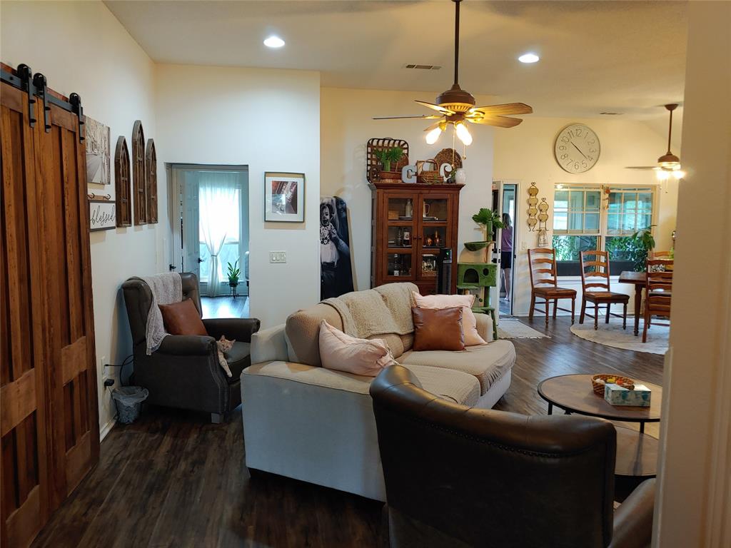 836 Airport Road Reno, TX 75462 - Photo 4 of 30 Spacious room featuring wood-finish flooring, recessed lighting, and a prominent ceiling fan