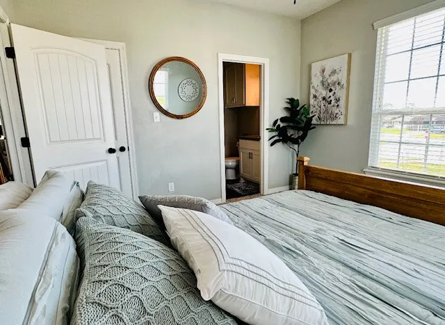 a bedroom with a bed and a window