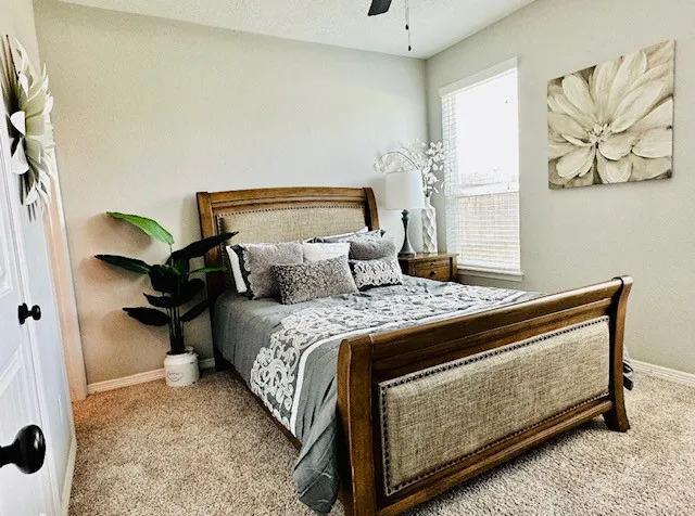 a bedroom with a bed and wall painting