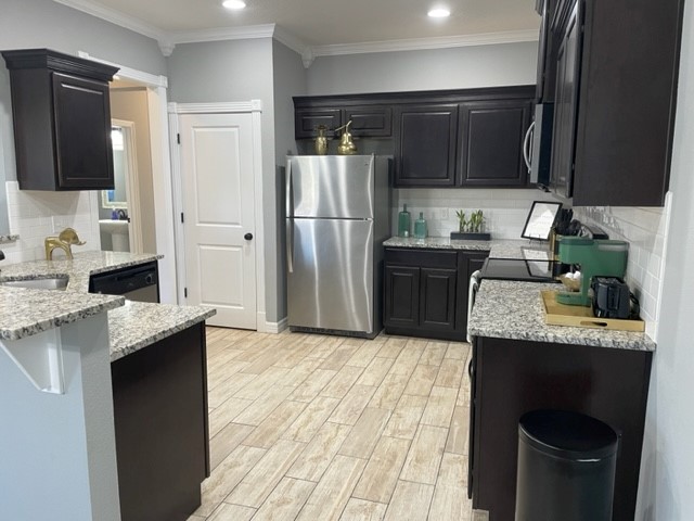 6939 Halter Loop College Station, TX 77845 - Photo 22 of 33 a kitchen with stainless steel appliances granite countertop a sink stove and refrigerator