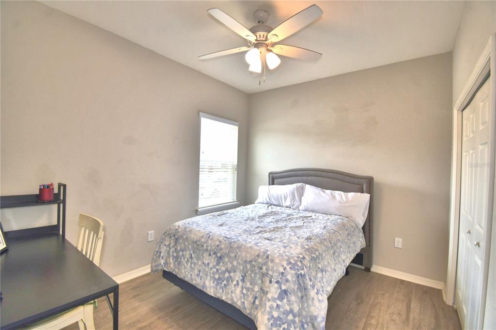 4340 Reding Way Lakeland, FL 33813 - Photo 34 of 63 a bedroom with a bed and a chandelier