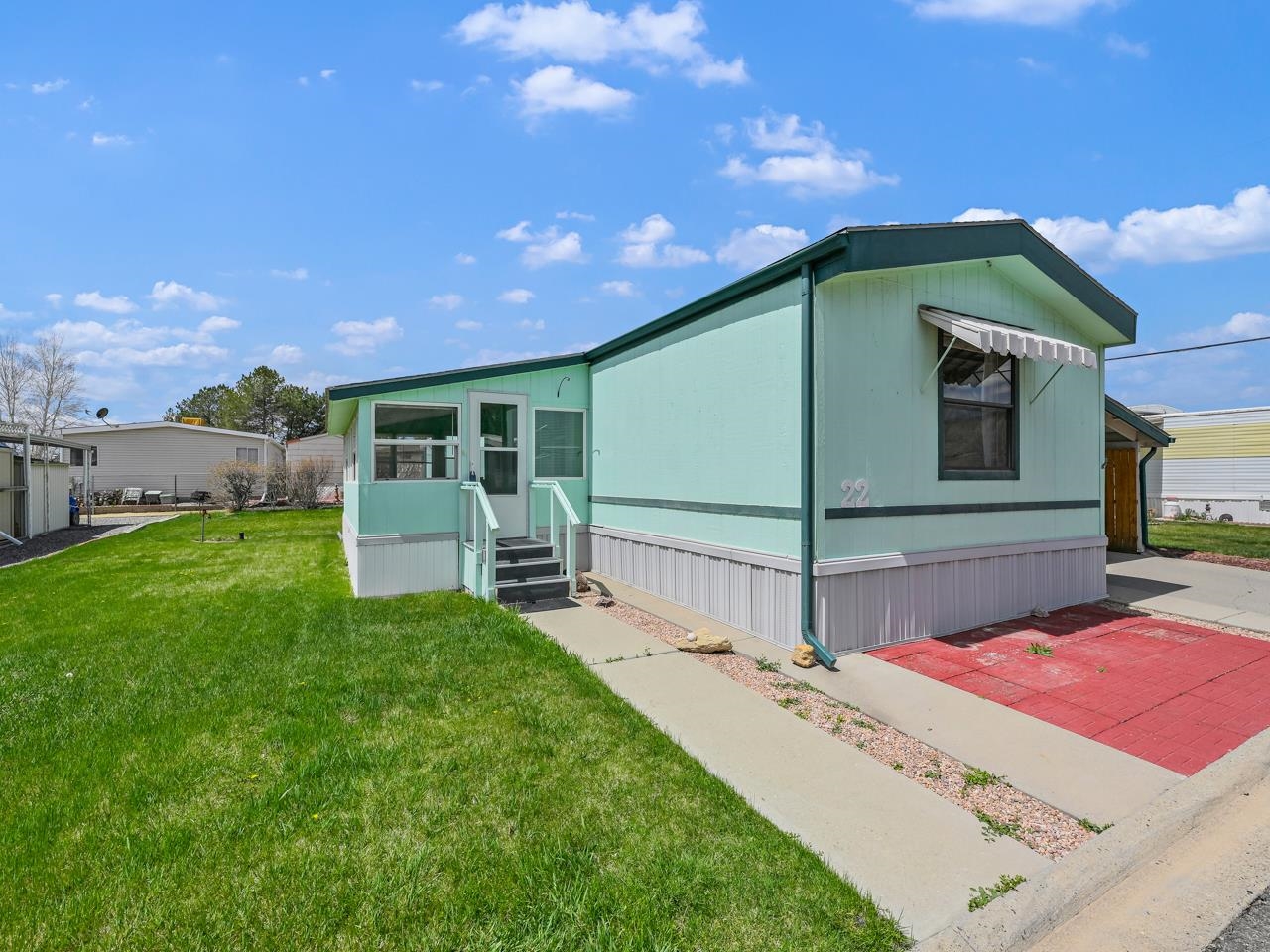 a view of an house with backyard space and balcony