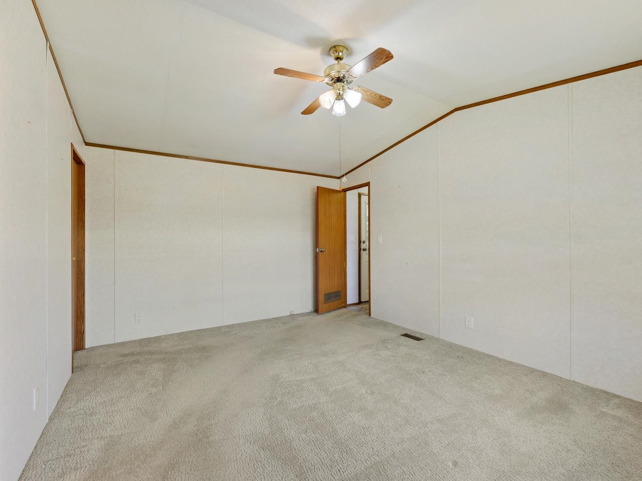 3195 F Road, Unit 22 Grand Junction, CO 81504 - Photo 12 of 24 a view of an empty room with chandelier fan