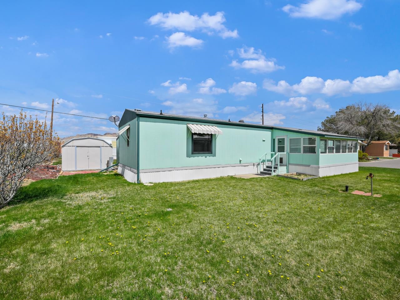 3195 F Road, Unit 22 Grand Junction, CO 81504 - Photo 23 of 24 a backyard of a house with lots of green space and fountain