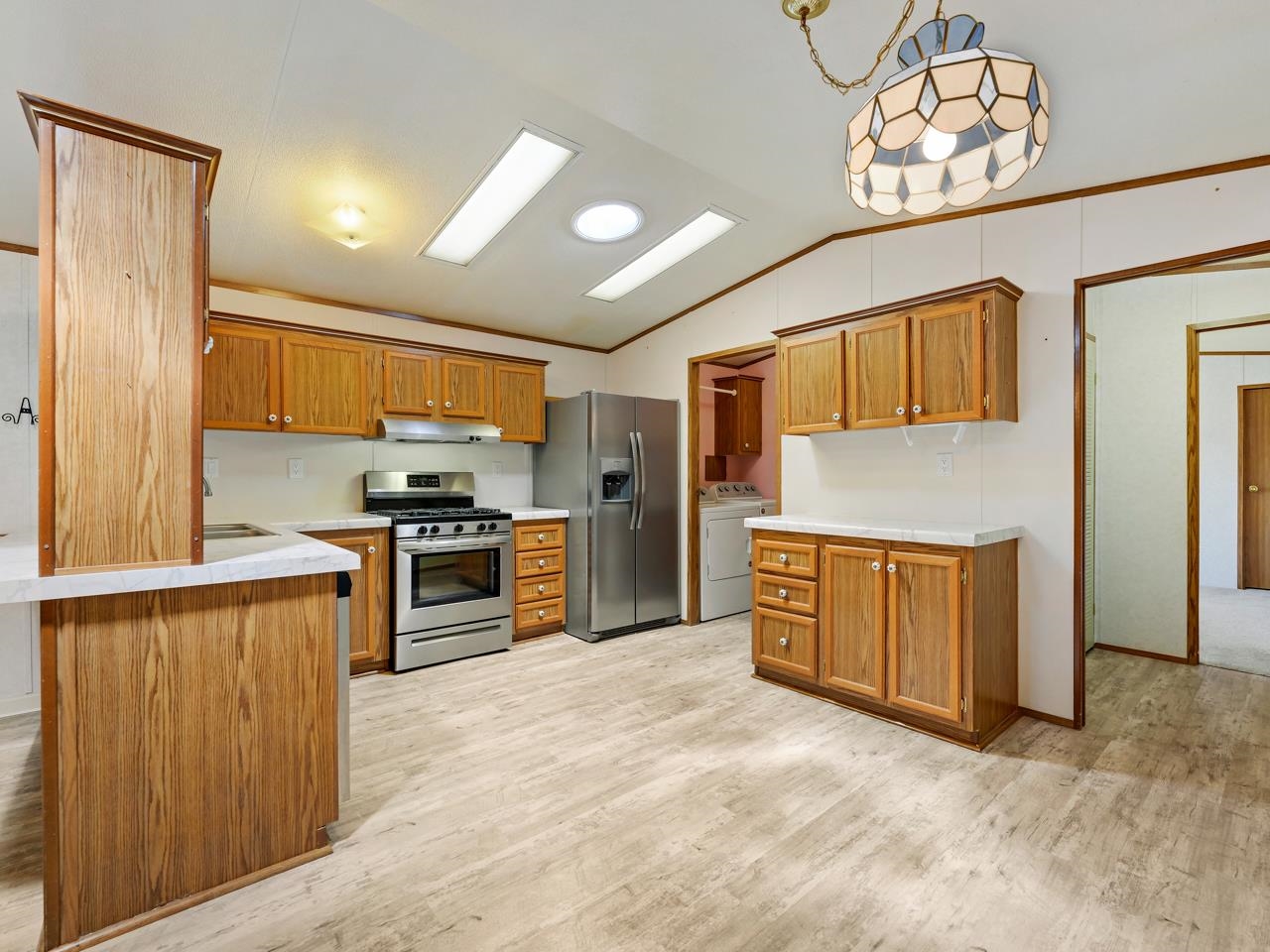 3195 F Road, Unit 22 Grand Junction, CO 81504 - Photo 7 of 24 a kitchen with stainless steel appliances granite countertop a refrigerator and a stove top oven