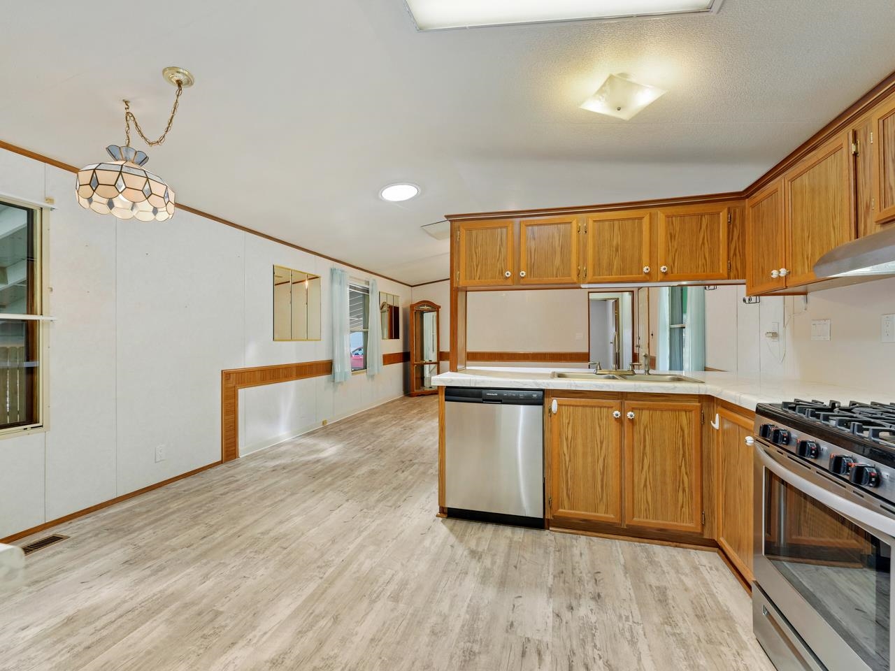 3195 F Road, Unit 22 Grand Junction, CO 81504 - Photo 9 of 24 a kitchen with stainless steel appliances granite countertop a stove a sink and a refrigerator