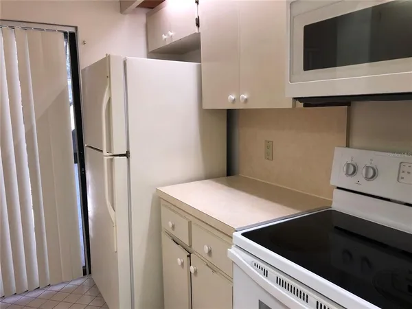 a kitchen with a refrigerator and a microwave