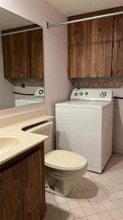 a bathroom with a toilet a sink and a shower
