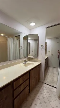 a bathroom with a sink a mirror and a shower