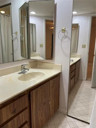 a bathroom with a double vanity sink a and mirror
