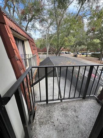 a view of wooden house with a deck