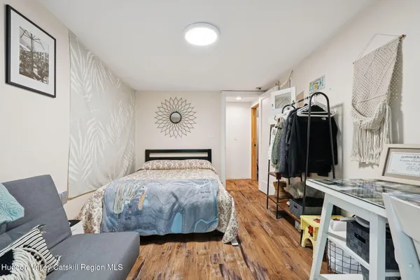 a bedroom with bed and a mirror