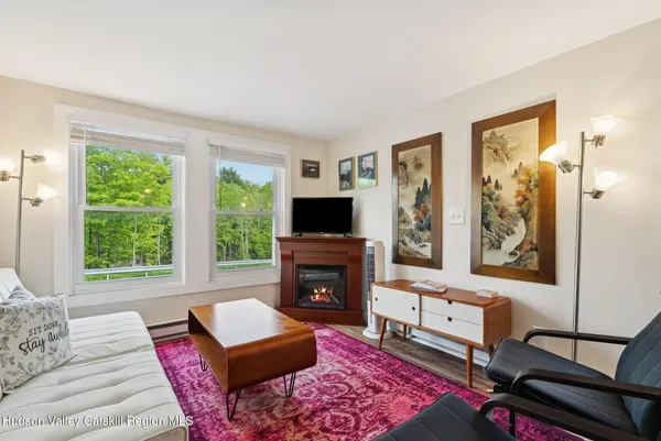 a living room with furniture a flat screen tv and a fireplace