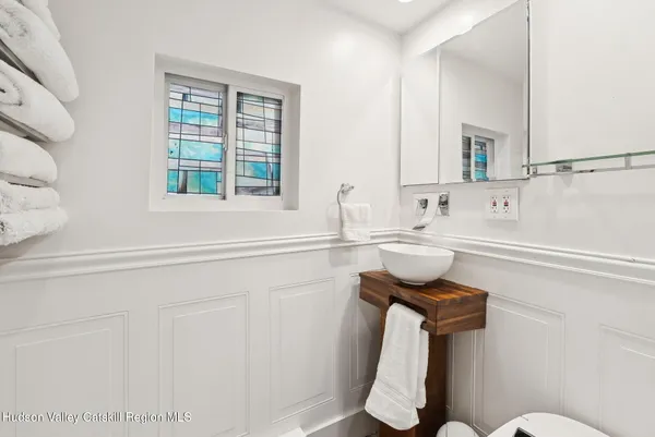 a bathroom with a sink toilet and mirror