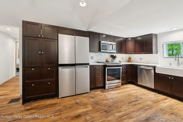 a kitchen with a refrigerator and a sink