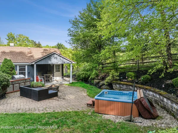 a view of a house with backyard sitting area and garden
