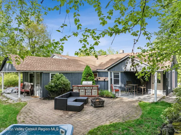 a view of house with backyard and sitting area