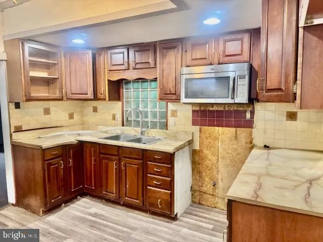 a kitchen with wooden cabinets and a sink