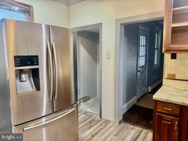 a kitchen with stainless steel appliances granite countertop a refrigerator and a stove