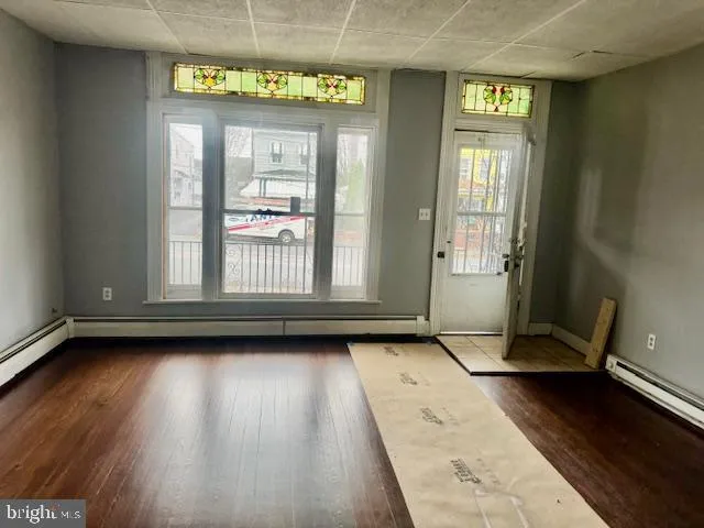 a view of a room with wooden floor