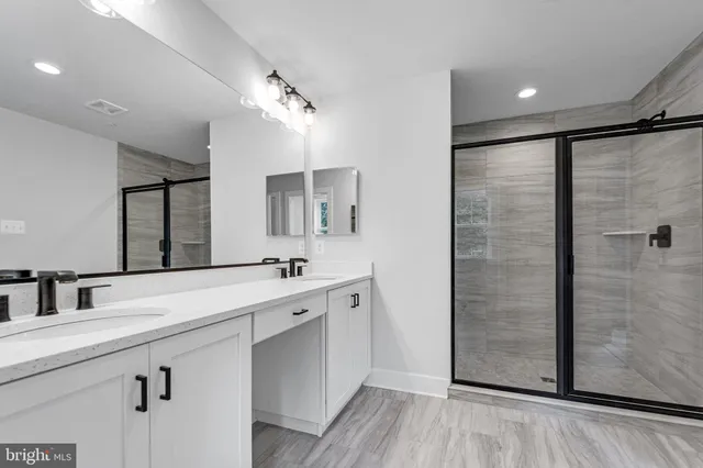 a bathroom with a double vanity sink and mirror