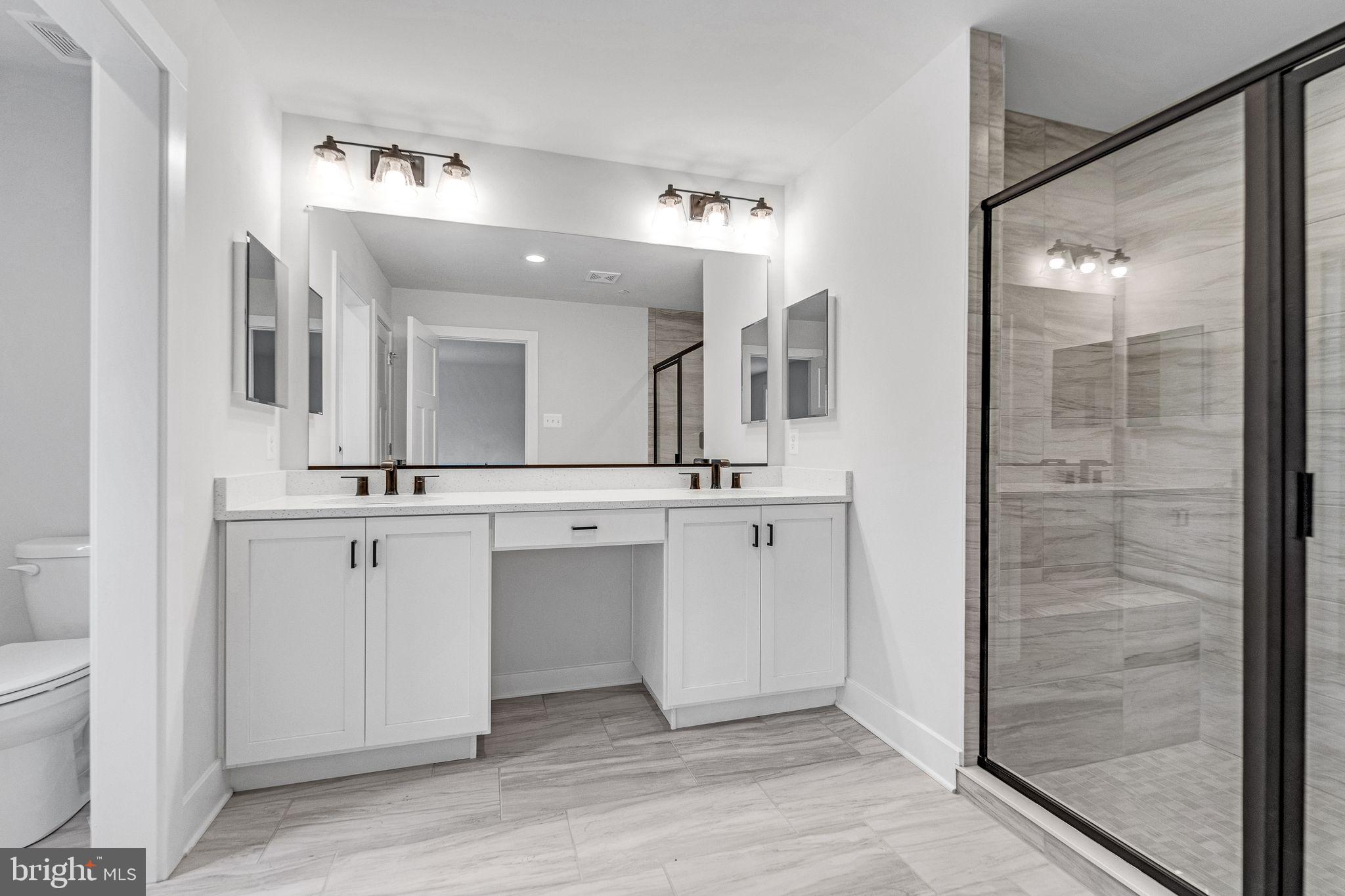 1315 Old Fallston Road Fallston, MD 21047 - Photo 19 of 46 a bathroom with a double vanity sink mirror and a shower