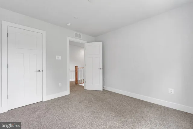 a view of a closet area with hardwood floor