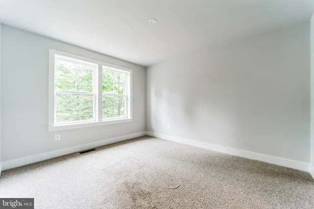 a view of an empty room with stairs and stairs